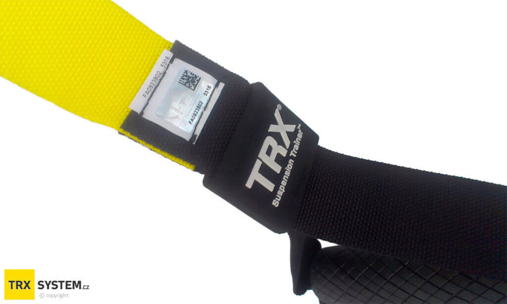 Transparent label sewn onto the strap underneath the rubber TRX badge above the handle