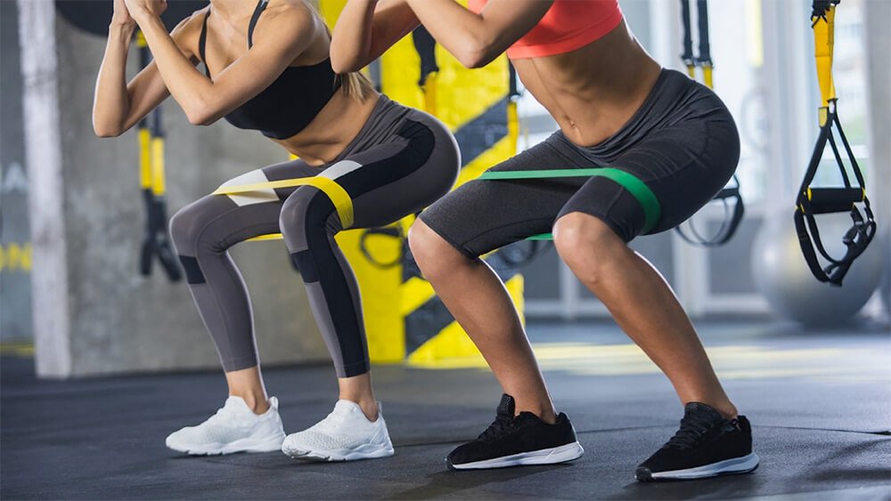 Suspension trainer straps and elastic resistance bands shown side by side for comparison